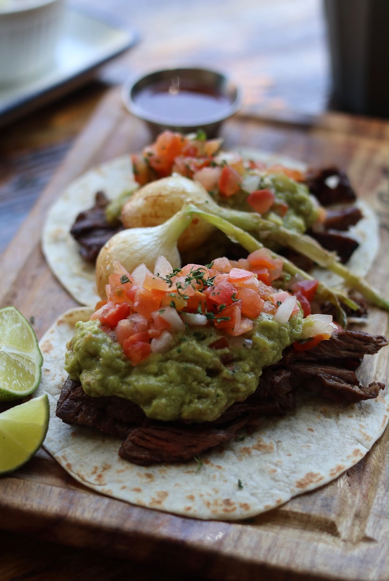 Carne asada taco with guacamole and pico de gallo