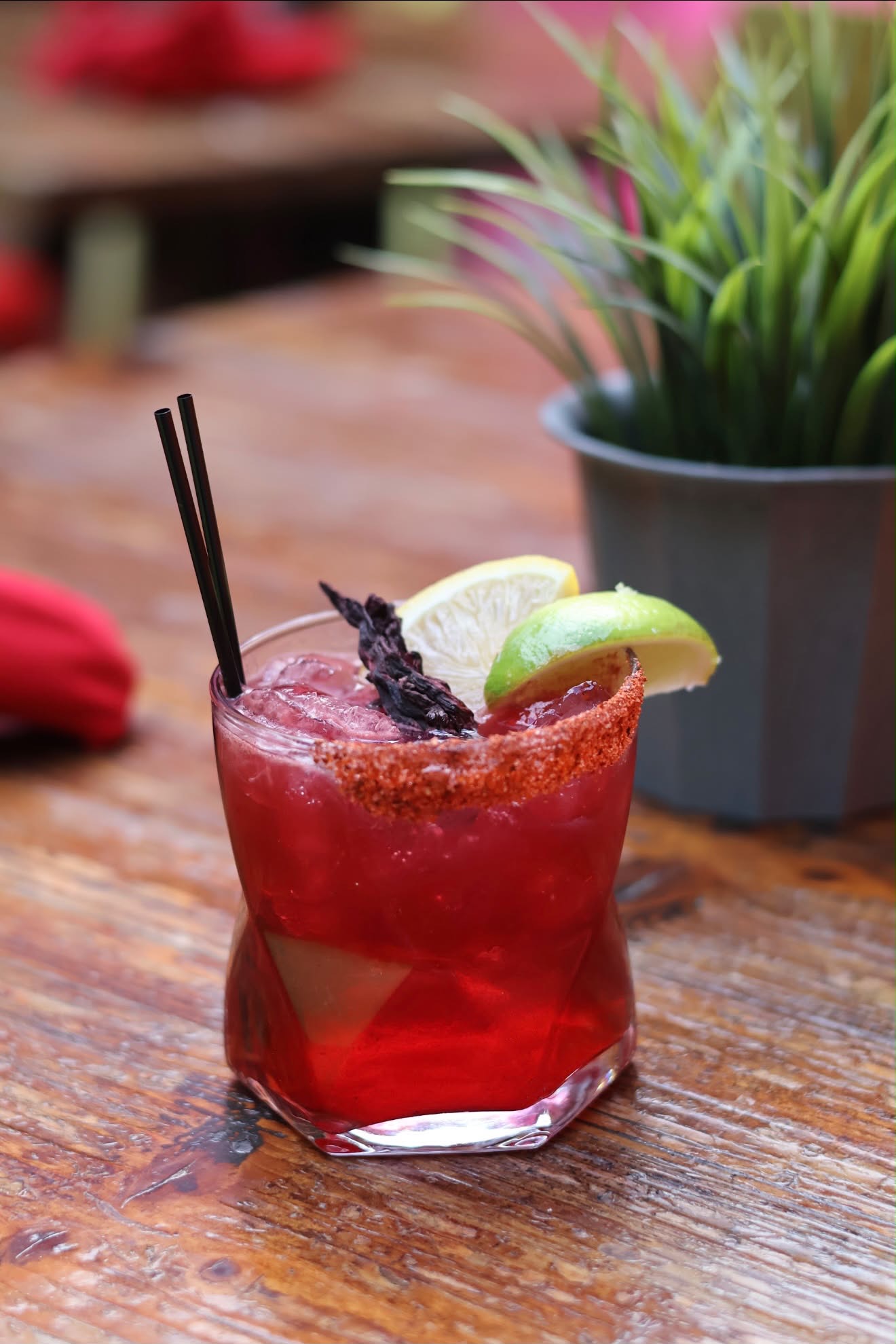 Red cocktail garnished with lime at El Patio